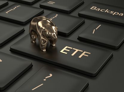 gold bear on black keyboard key that says ETF