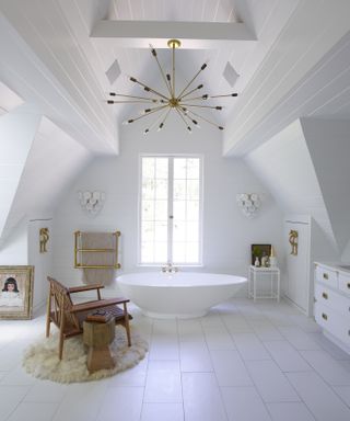 Large white bath tub in all-white bathroom
