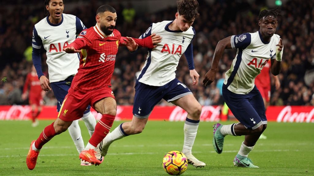 Mohamed Salah of Liverpool and Archie Gray of Tottenham Hotspur during the Premier League match between Tottenham Hotspur FC and Liverpool FC at Tottenham Hotspur Stadium on December 22, 2024 in London, England.