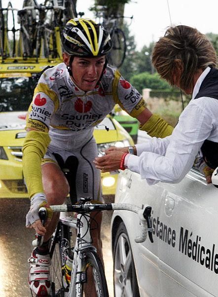 Ricc&ograve; hangs on to the doc's car while getting treatment for his crash injuries.