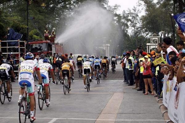 Fire engines spray the riders to keep them cool