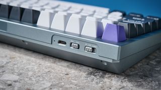 A photo of the Keychron Q1 Pro in gray aluminum with white, black and purple keycaps.