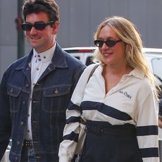 Chloë Sevigny is seen with husband Siniša Mačković in New York wearing shorts, black boots, and a J.Crew The New Yorker shirt, matching with a brown bag and a Knicks hat.