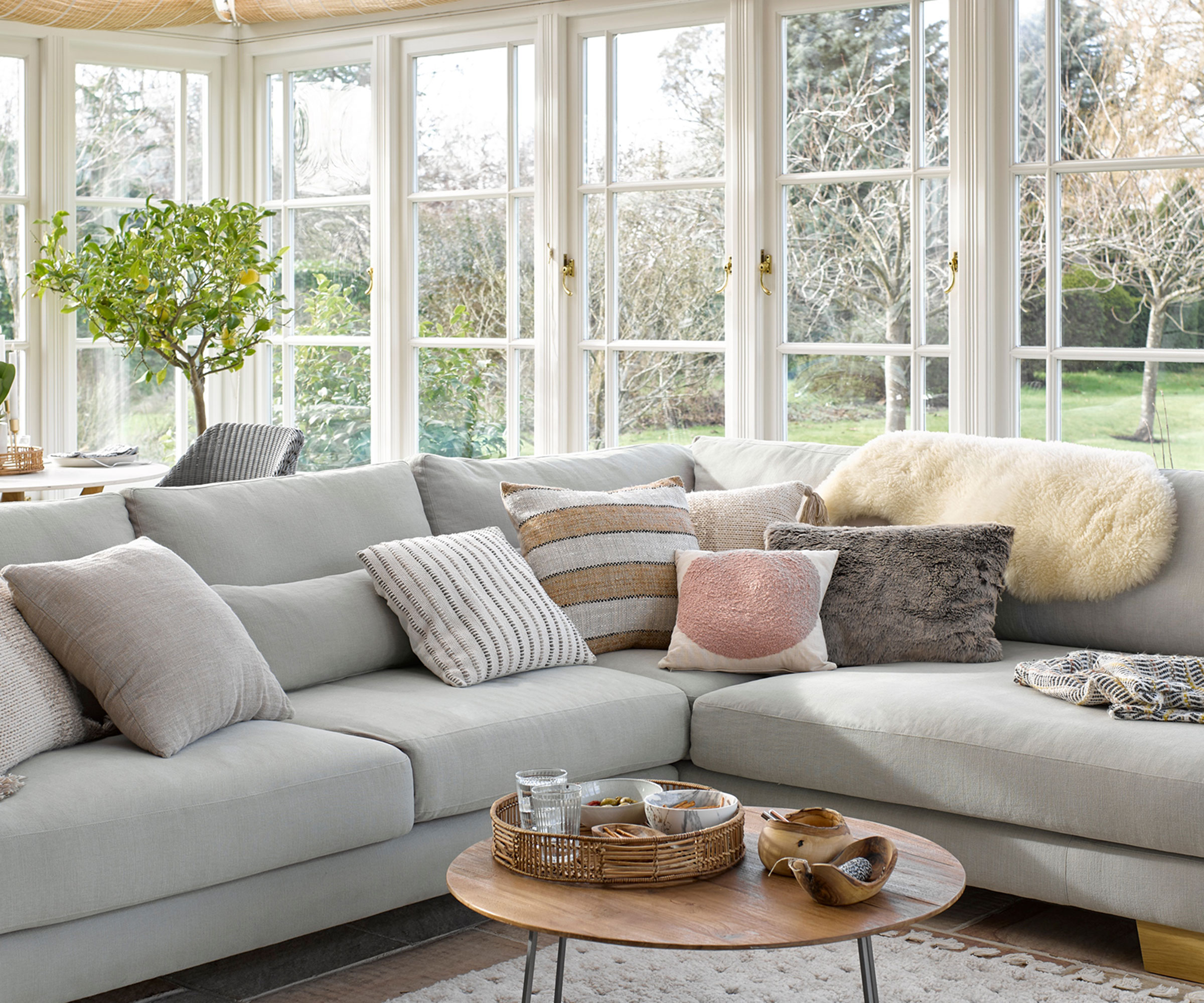 orangery style conservatory with large grey corner sofa