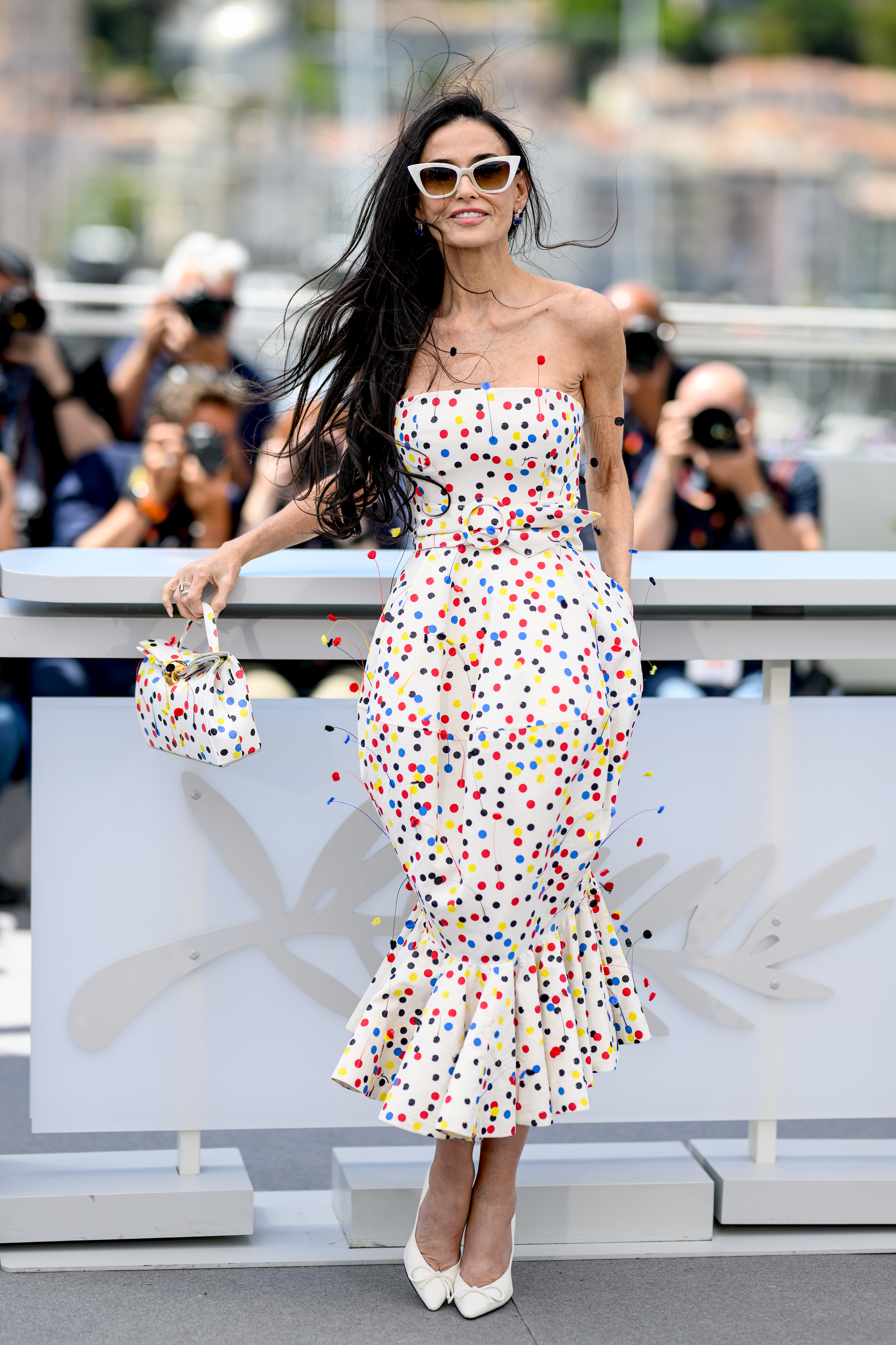 Demi Moore arrived at the 2026 Cannes Film Festival in a multi-color polka-dot little white dress