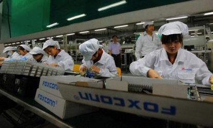 Foxconn employees work on the production line at a factory in the southern Chinese city of Shenzhen.