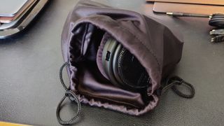 The Sennheiser HD-660S2 over-ear headphones in a small bag.