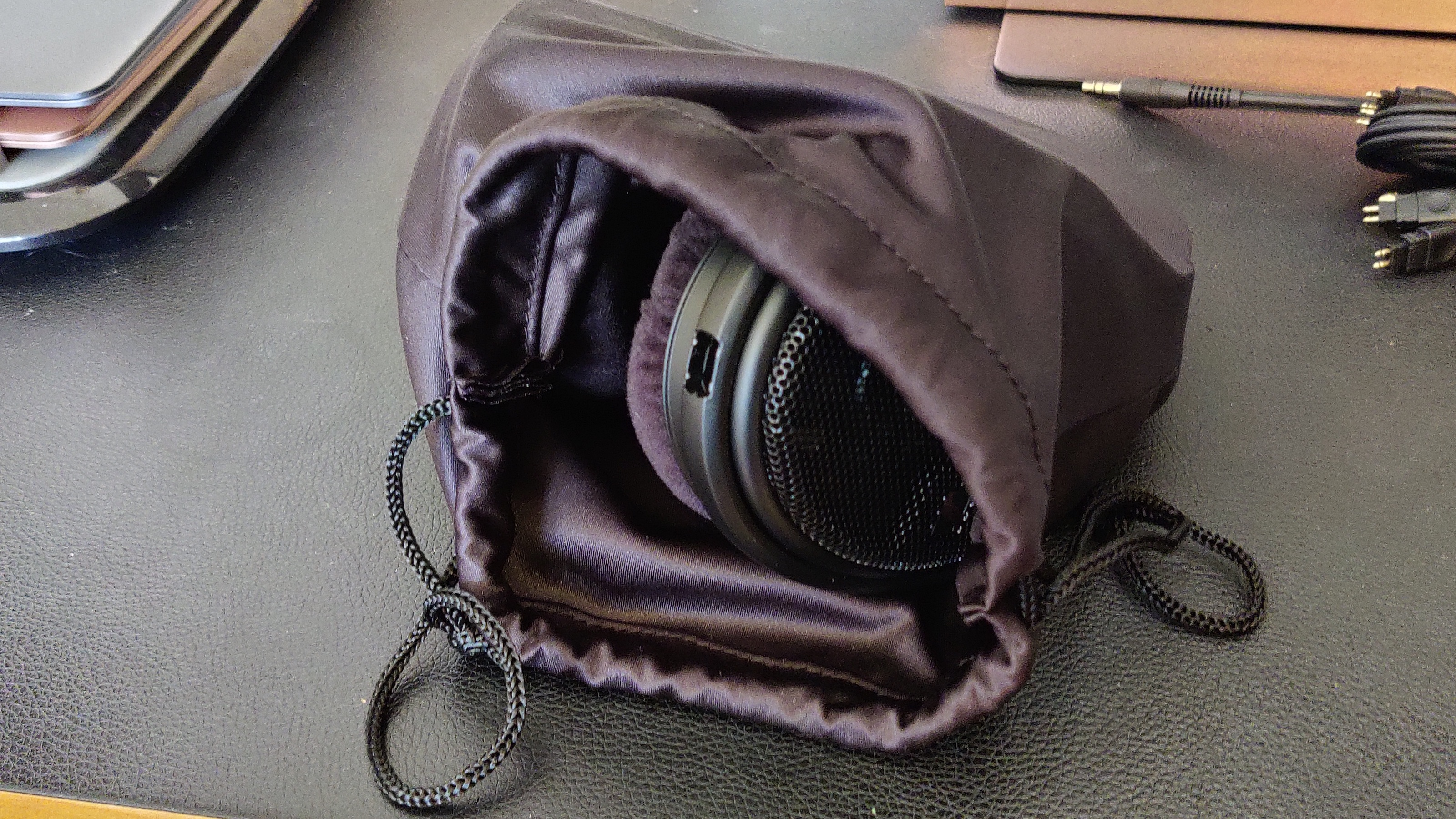 The Sennheiser HD-660S2 over-ear headphones in a small bag.
