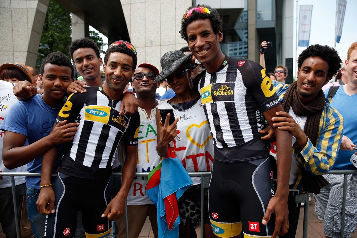 UTRECHT, NETHERLANDS - JULY 05: (L-R) Merhawi Kudus of Eritrea riding for MTN-Qhubeka and Daniel Teklehaimanot of Eritrea riding for MTN-Qhubeka pose for a photo with supporters prior to the start of stage two of the 2015 Tour de France from Utrecht to Zelande on July 5, 2015 in Utrecht, The Netherlands. (Photo by Doug Pensinger/Getty Images)