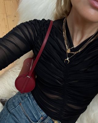 British fashion influencer Lucy Williams wearing a red barrel bag from Proenza Schouler