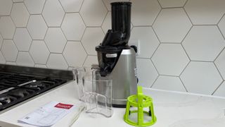 Kuvings B1700 and its accessories on a kitchen countertop