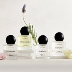 quince perfume bottles with flowers on white background