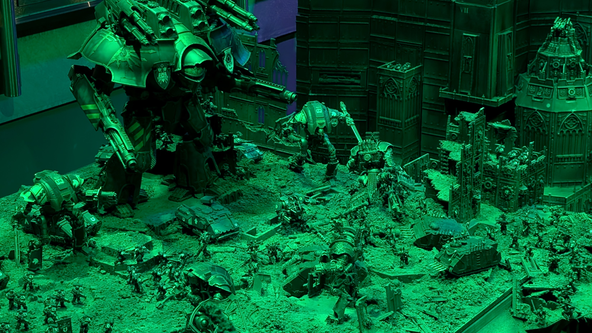 Titans march over a battlefield in Warhammer 40K