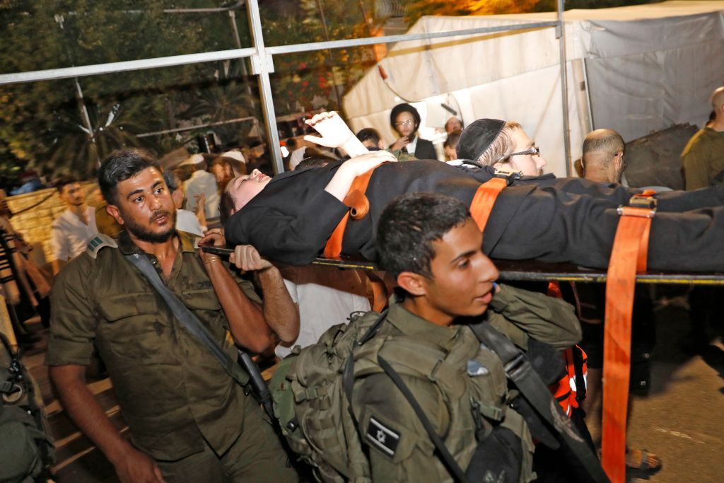 Medics carry a victim on a stretcher.