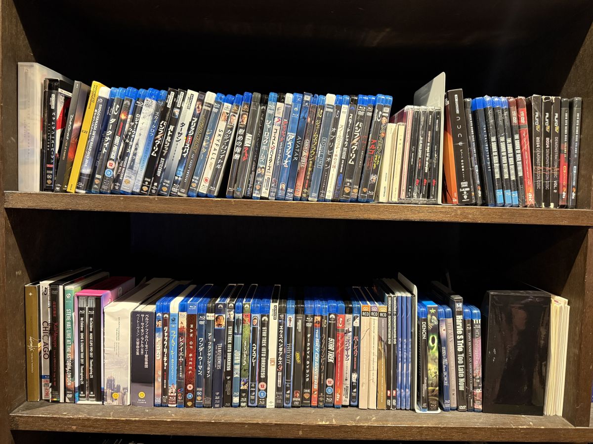 Two shelves full of Blu-ray discs (and some CDs and DVDs)