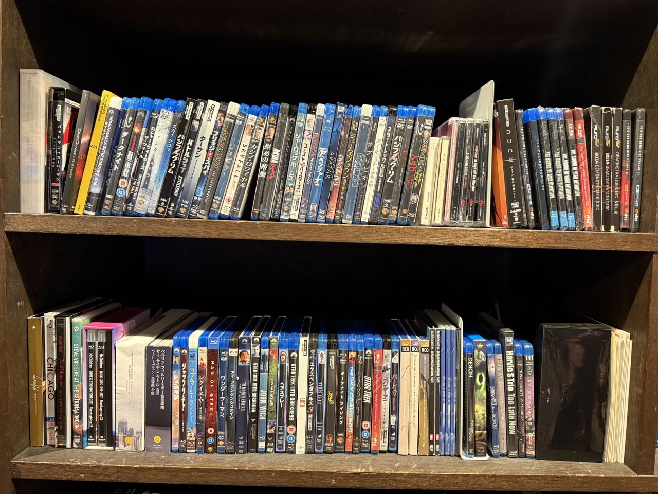 Two shelves full of Blu-ray discs (and some CDs and DVDs)