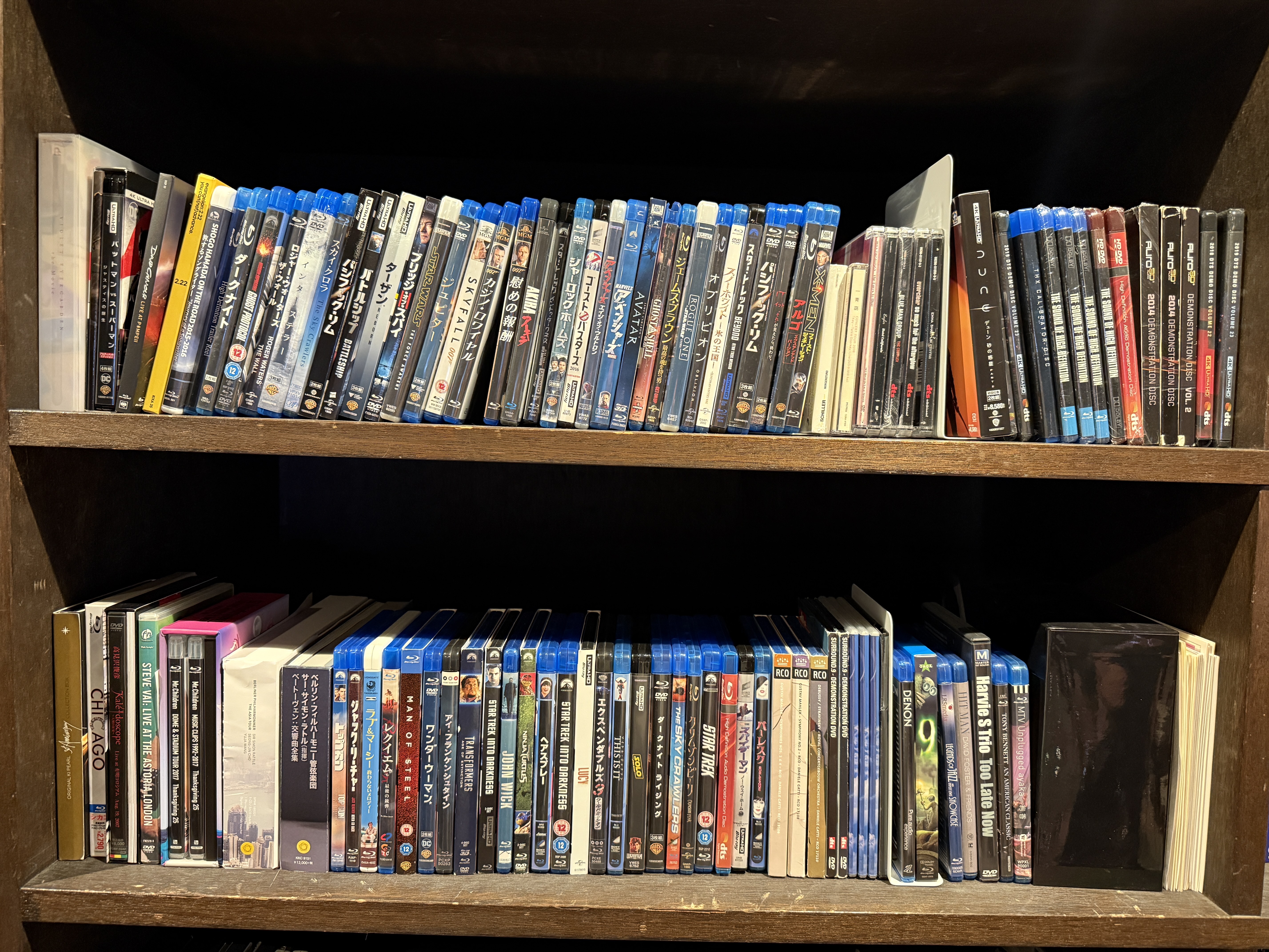 Two shelves full of Blu-ray discs (and some CDs and DVDs)