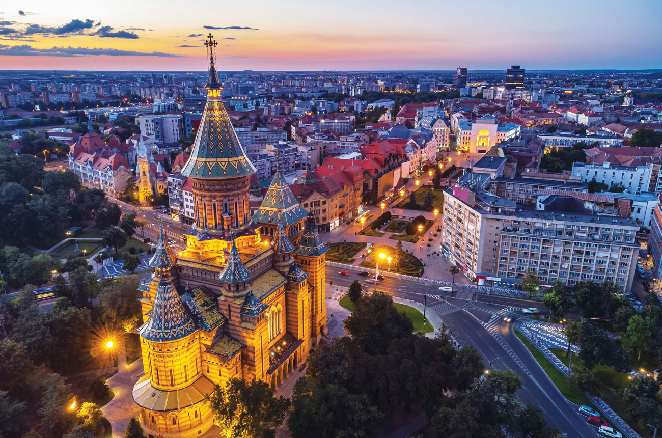 The late 1930s-built Timi&amp;#537;oara Romanian Orthodox cathedral and the night lights of the city centre.