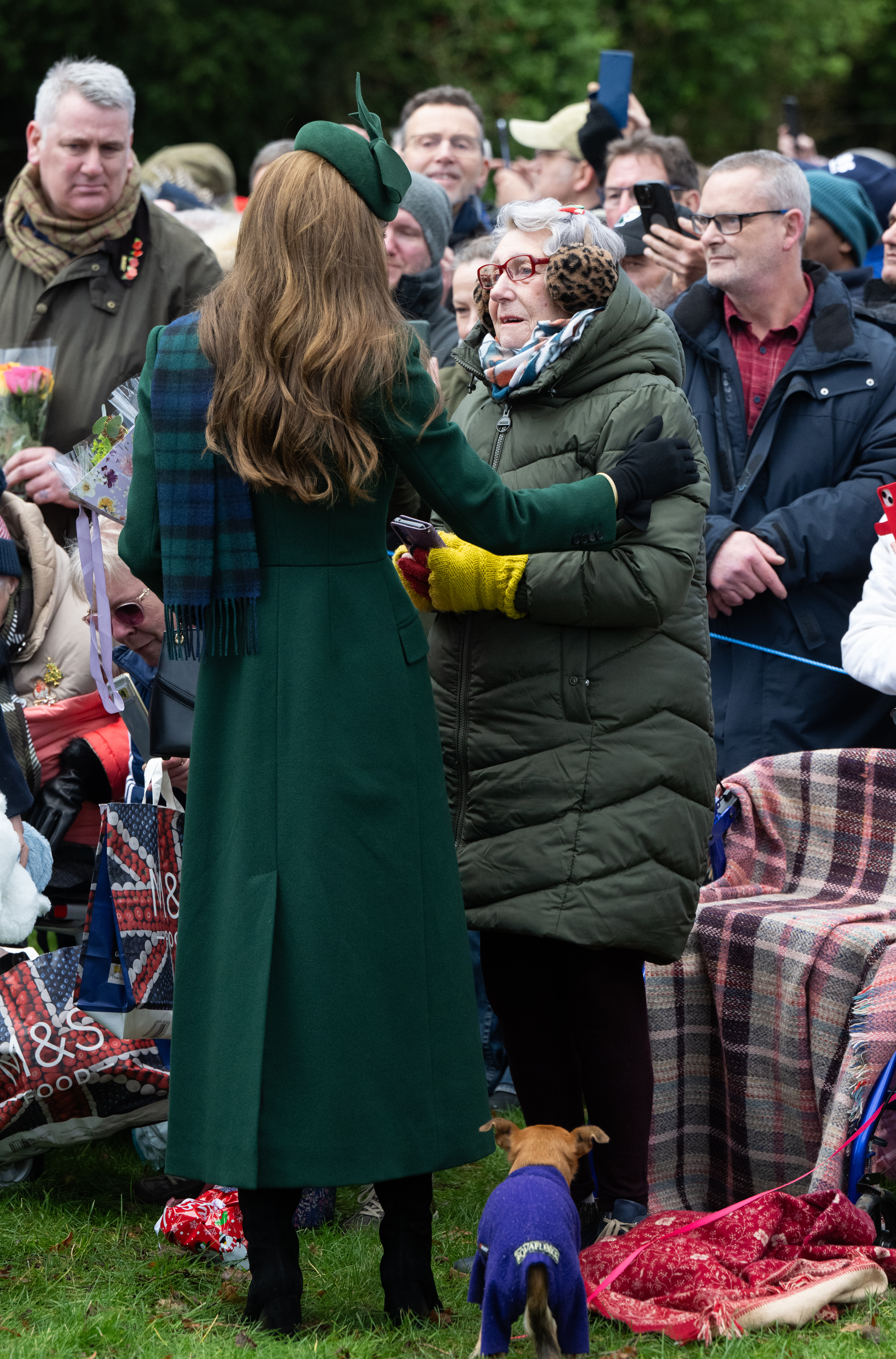Kate Middleton hugging a fan on Christmas Day in a green coat