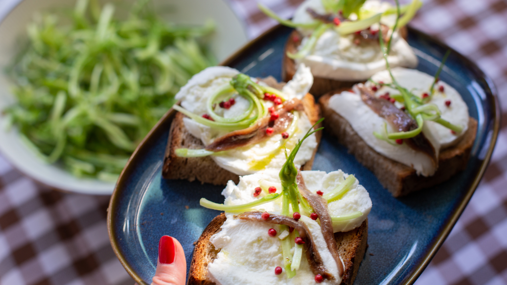 A plate of bruschetta with anchovies topping
