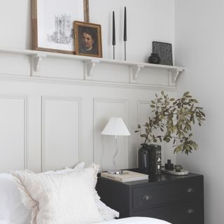 bedroom with shelf behind bed