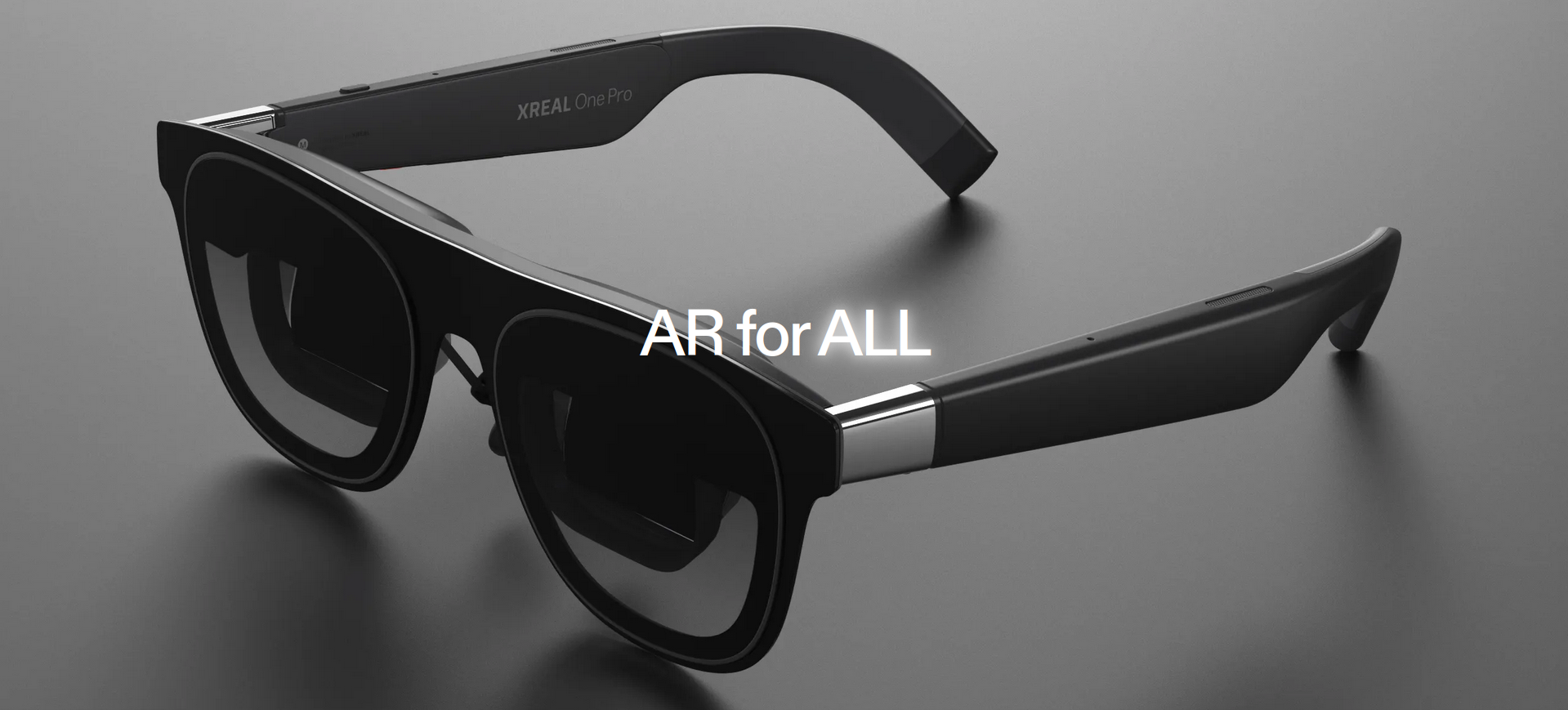A pair of XREAL One Pro glasses in front of a gray background