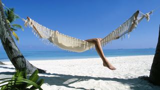 Woman relaxing in hammock