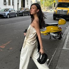 Influencer wears suede heeled sandals.