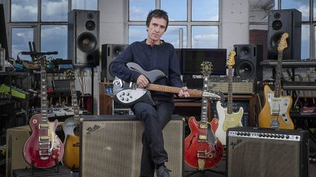 A photo of Johnny Marr holding a guitar.