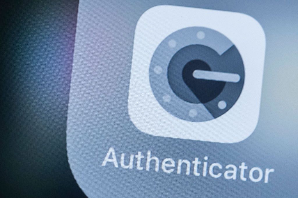 Google Authenticator logo, which is a grey &#039;G&#039; stylized to look like a tumbler lock