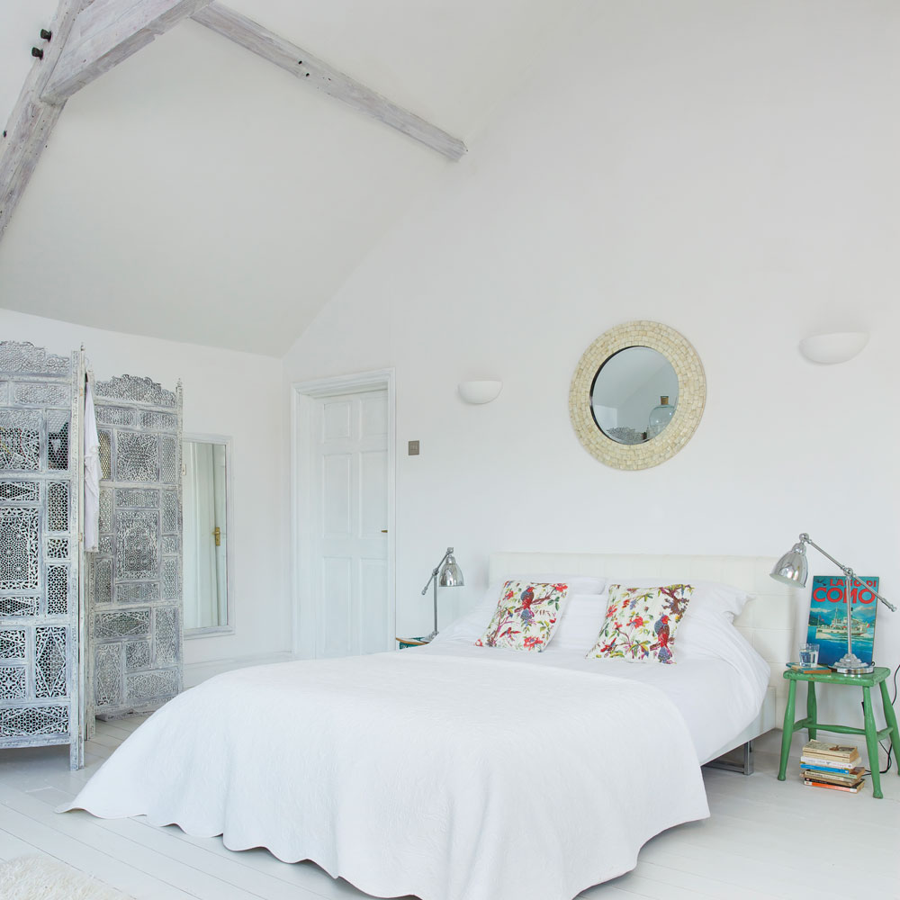 bedroom with white bedlinen and green metal stool