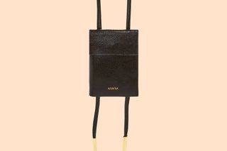 The black pebble leather Ashya bolo passport cover with gold hardware