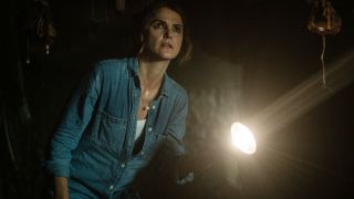 Keri Russell explores a creepy shed with a flashlight in Antlers.