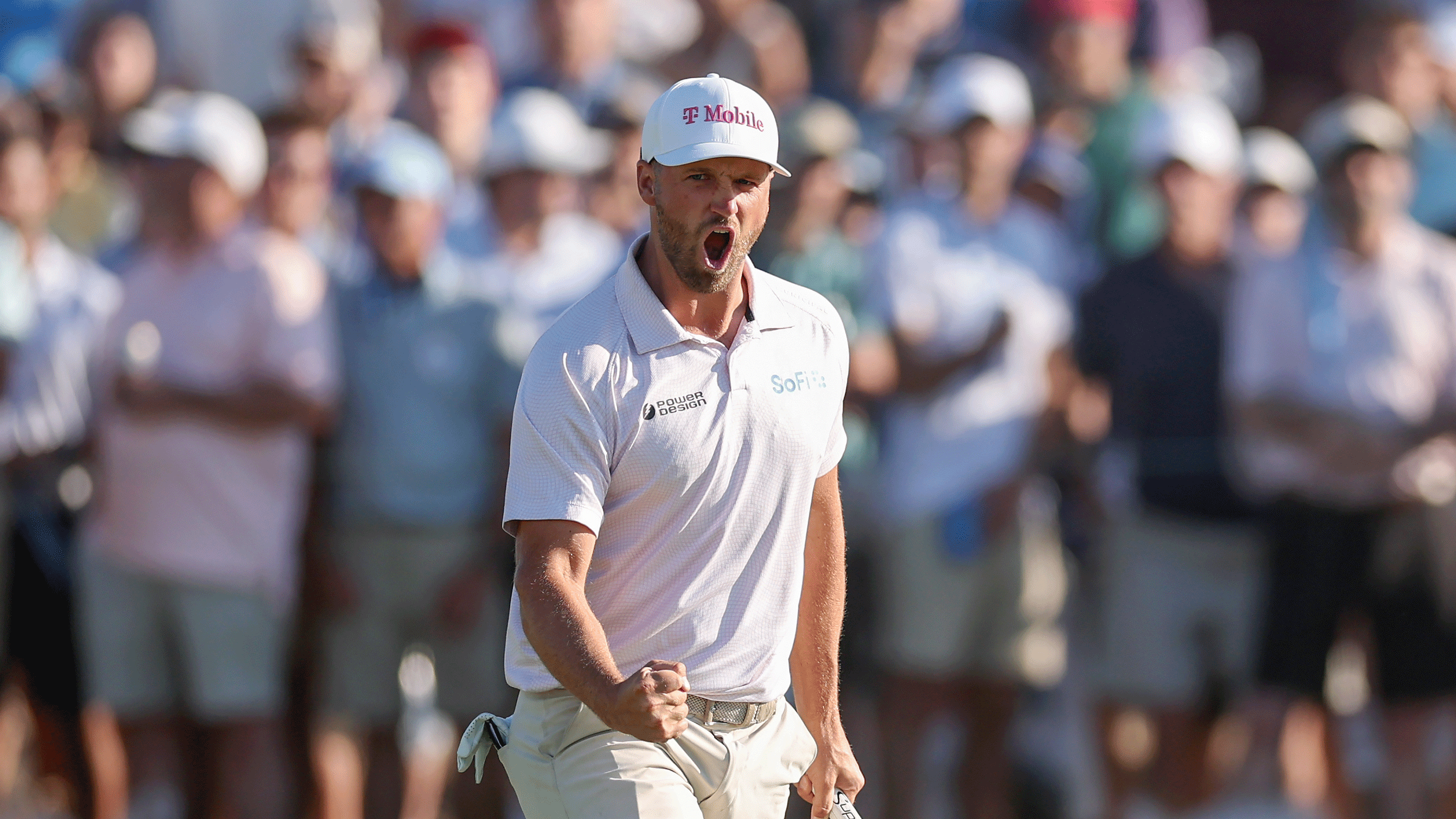 Wyndham Clark roars with delight and makes a clenched fist after holing the winning putt at the 2026 US Open