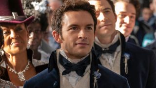 Jonathan Bailey smiles as he looks ahead in a church in Bridgerton, S3 E7 - "Joining of Hands."