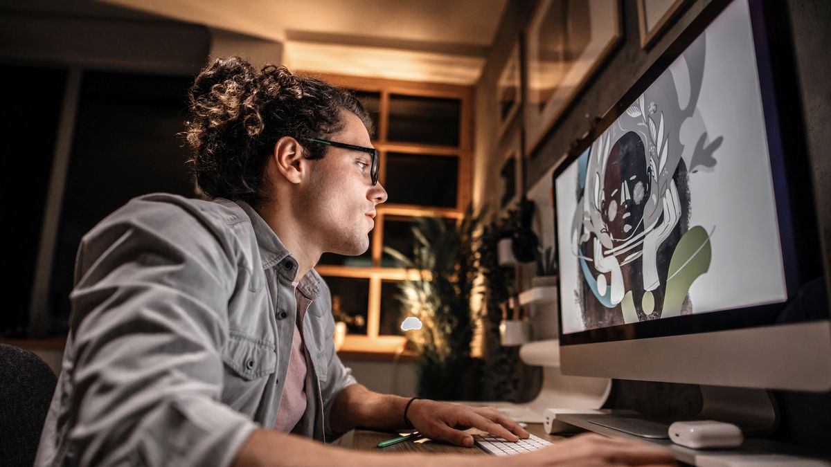 A man using an iMac to create abstract digital art work