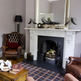 living room with white walls and marble fireplace