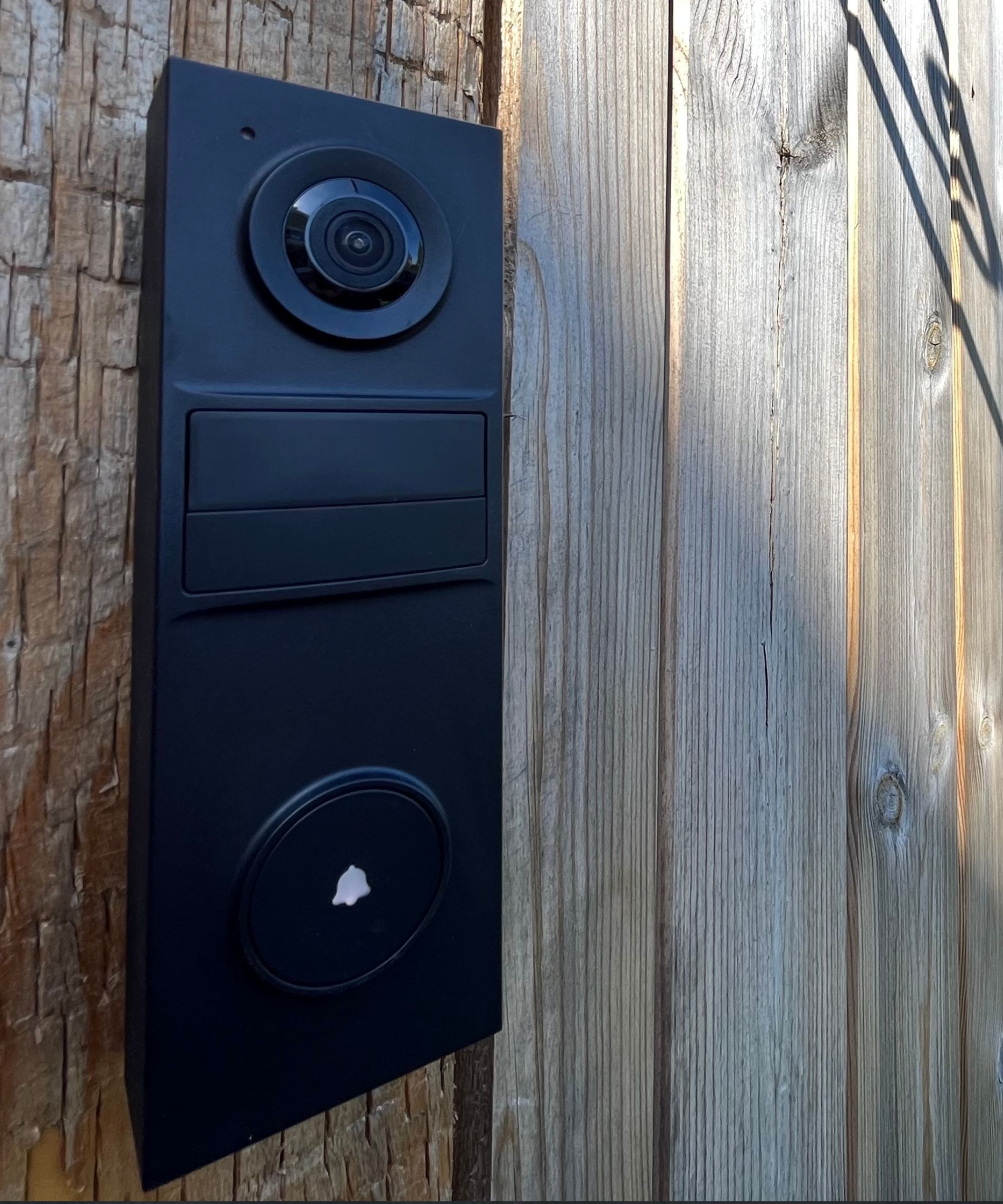 Tapo D205 Smart Video Doorbell installed on wooden fence