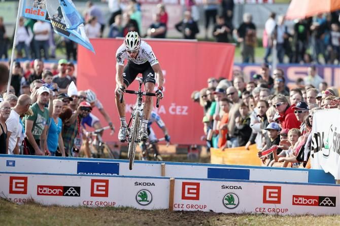 World champion Sven Nys bunny hops the barriers as he tries to ride back into contention following a crash in the Tabor World Cup