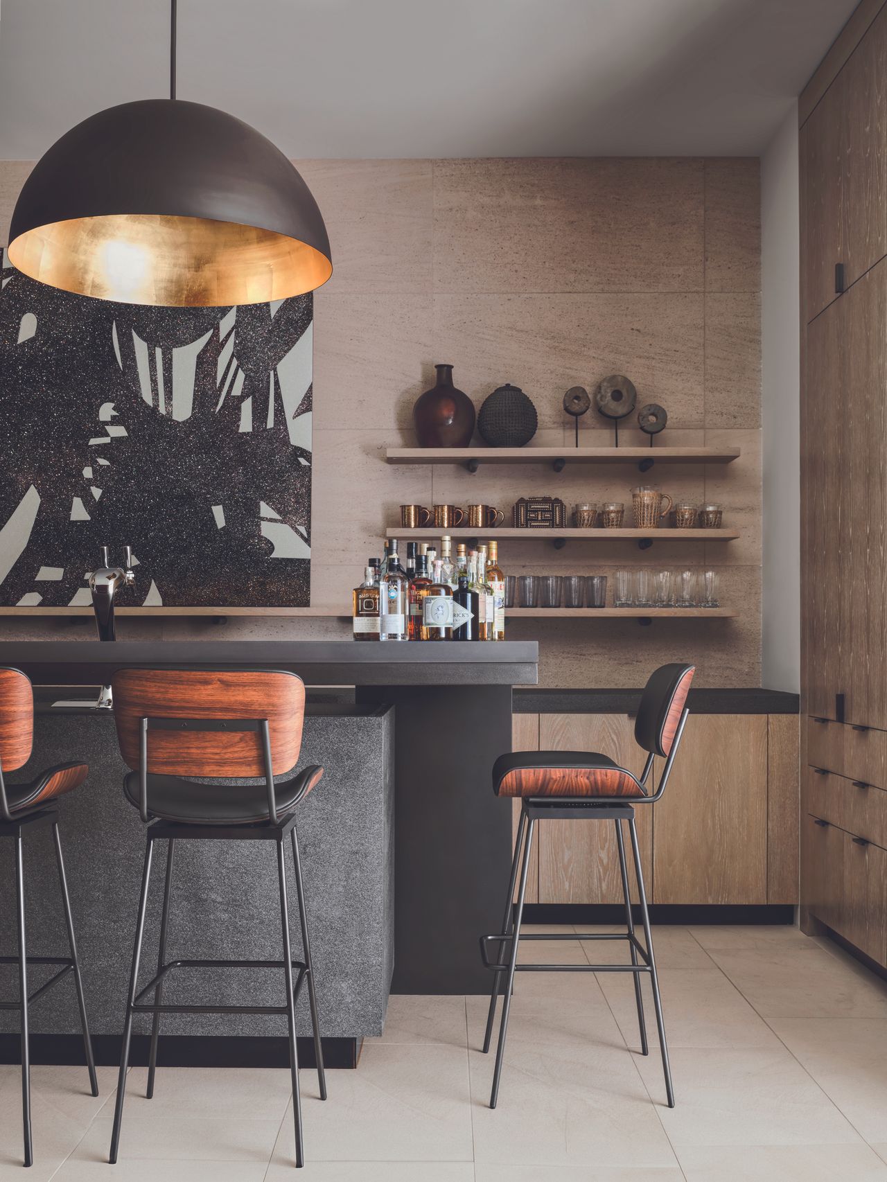 The kitchen and home bar featuring natural materials and wooden bar stools