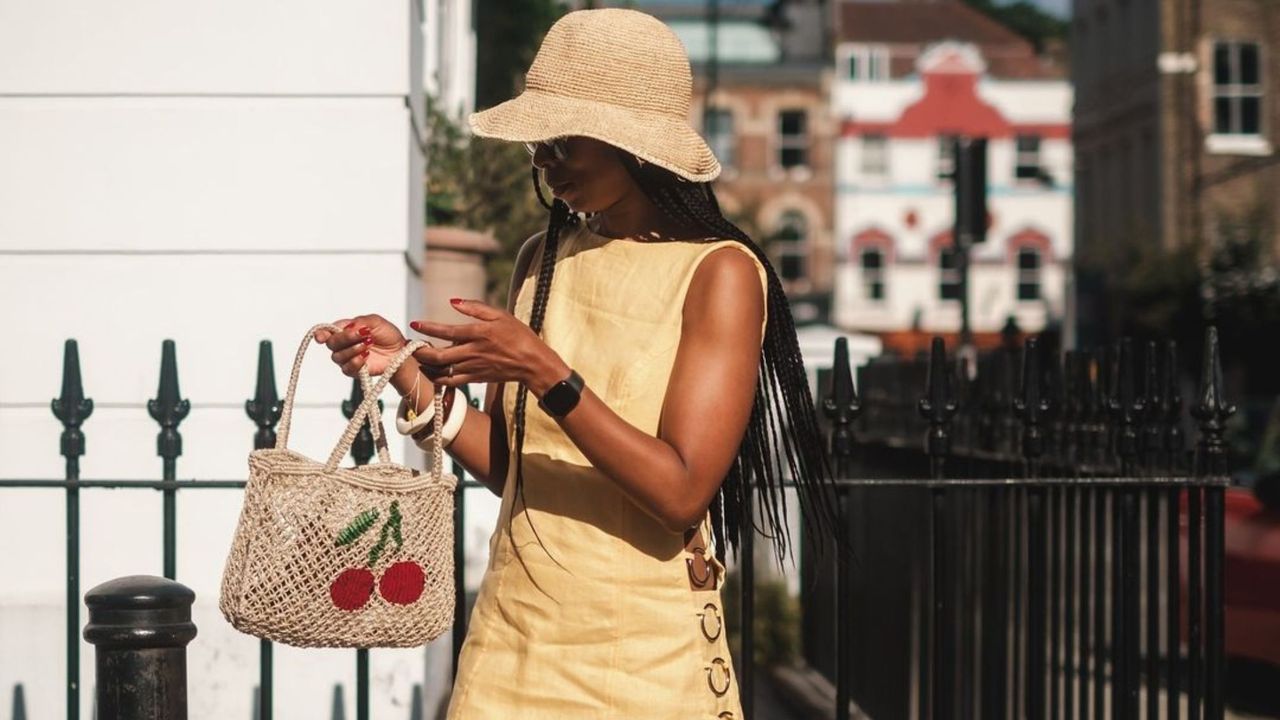 Thandi Maq carrying cherry print bag