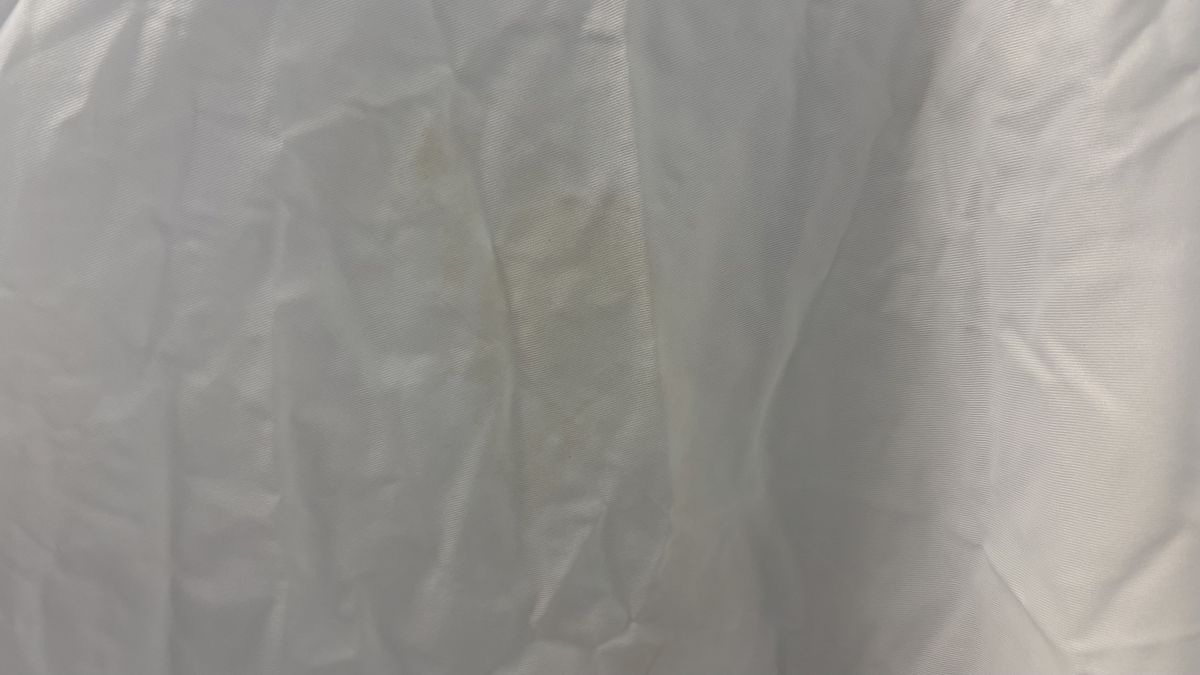 A close up of the Linenspa Mattress Protector. It shows light stains from tea or coffee