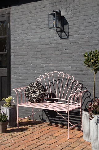 Subtle but statement pink iron garden bench