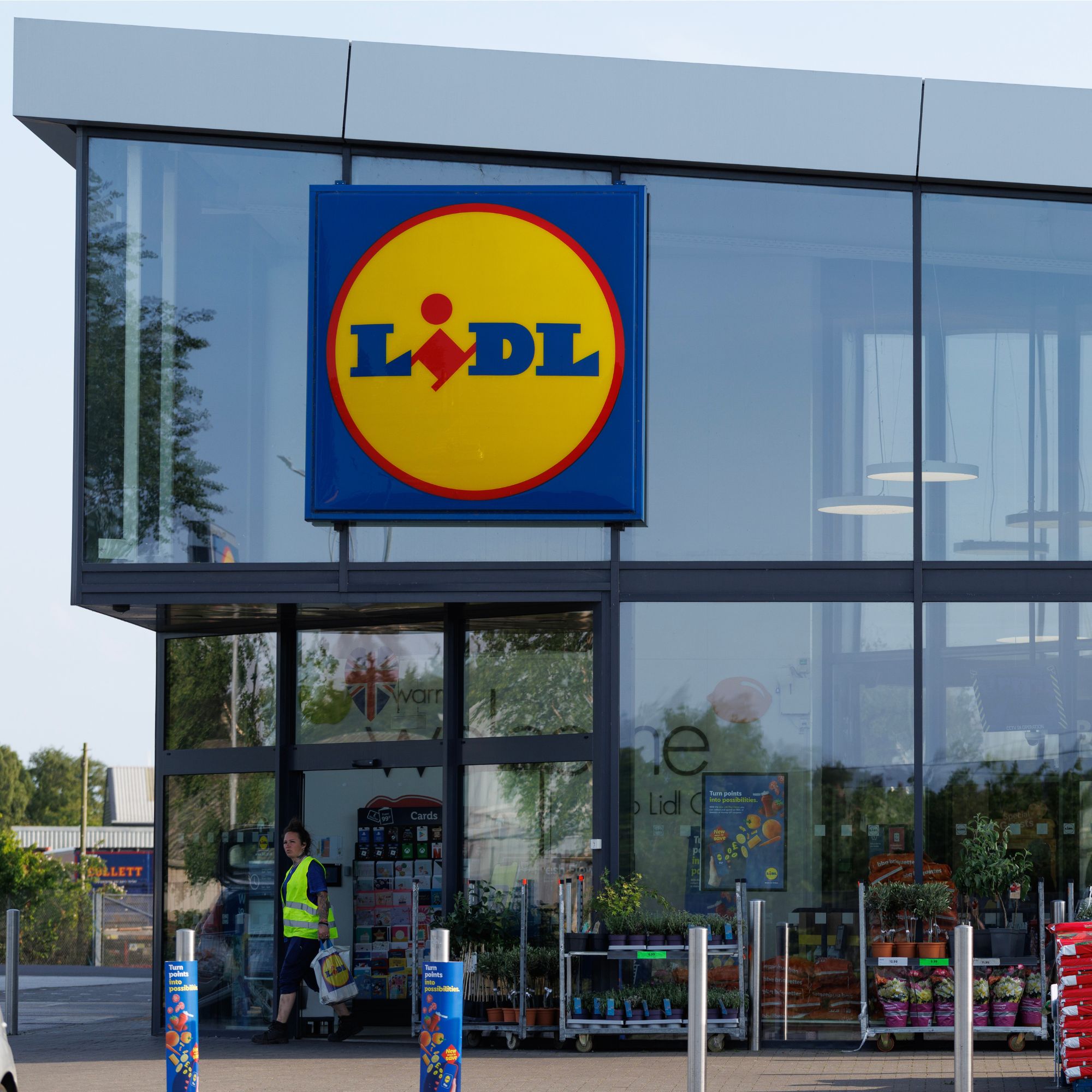 Exterior of a Lidl store, with glass walls and large Lidl logo