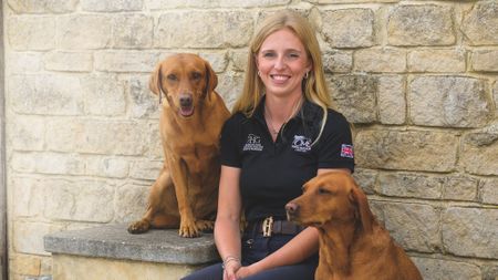 Event rider Cerys Macaulay with her two fox-red labradors