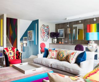 living room with beige sofas and bold accent colours throughout room