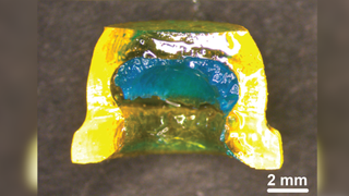 A small, yellow sucker-shaped device filled with a blue gel