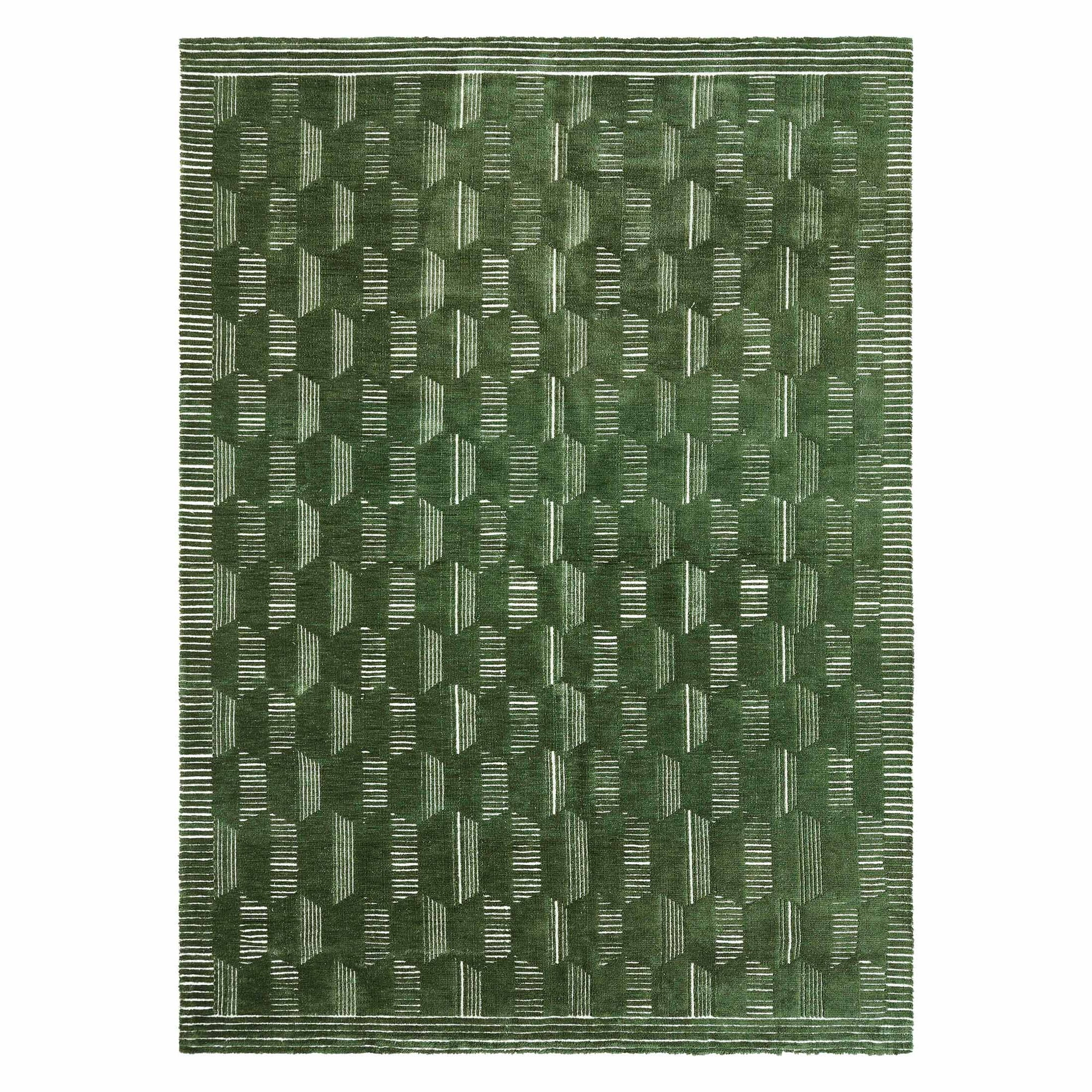 a green rug with geometric patterns