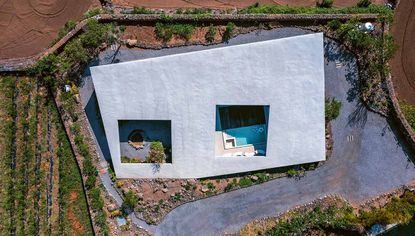 concrete house in countryside featured in Earth Works: Houses by Byoung Cho