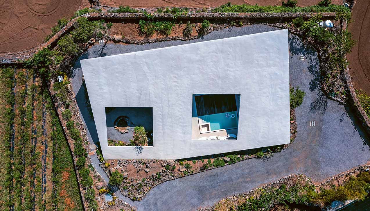 concrete house in countryside featured in Earth Works: Houses by Byoung Cho